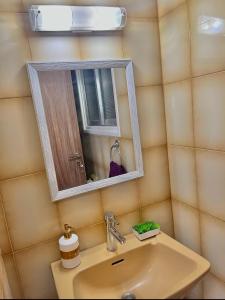 a bathroom with a sink and a mirror at Urban Retreat - Your Ideal Getaway in Limassol in Limassol