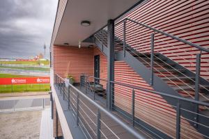 a balcony of a stadium with metal stairs at Quartier am Sachsenring in Oberlungwitz
