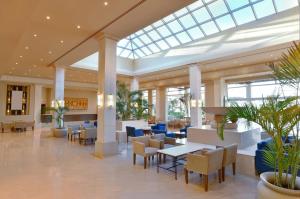 um átrio de um hotel com mesas e cadeiras em Iberotel Casa Del Mar Resort em Hurghada