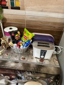 a shelf with a toaster and a basket of food at Luxury Apartment City stars in Cairo