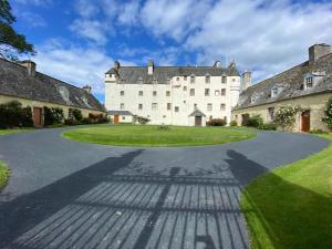 an estate with a large white building with a driveway at Quaint & Cozy Cottage, Private garden & bike shed in Innerleithen