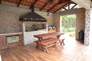 an outdoor kitchen with a wooden table and a stove at Casa de Campo Solar Tere in Cochabamba