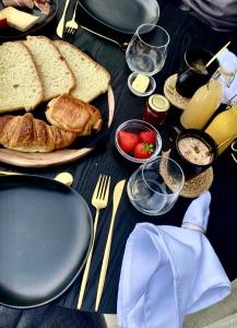 a table topped with plates of bread and toast at La bulle du Bon'Heure in Somme-Leuze