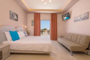 a bedroom with a bed and a couch and a window at Mary Elen Boutique Hotel in Argasi