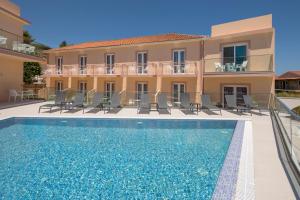 a villa with a swimming pool in front of a building at Mary Elen Boutique Hotel in Argassi