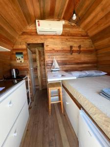 a small bedroom with a bed in a tiny house at Floripa Glamping in Florianópolis