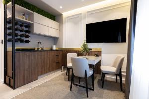 a kitchen with a table and chairs and a tv at RIVA sleep & chill in Valjevo