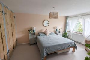 a bedroom with a bed and a mirror on the wall at 1 Mint Park Road in Braunton