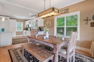 a dining room with a wooden table and a kitchen at Lake Sinclair in Eatonton