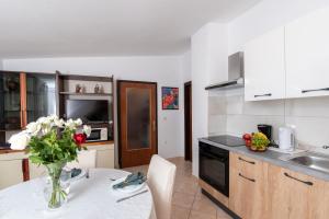 a kitchen with a vase of flowers on a table at Apartment Sirol in Labin