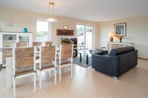 a living room with a couch and a table and chairs at Ferien im Maigen in Mettlach