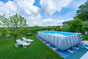 a large swimming pool with chairs and a table at Apartment Sirol in Labin