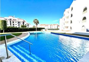 a large swimming pool in front of a building at AREIAS SOL in Albufeira