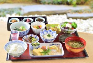 Hotel Nikko Fukuoka في فوكوكا: صينية مع أطباق مختلفة من الطعام على طاولة