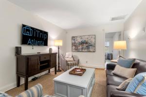 a living room with a couch and a tv at Discover Decatur in Decatur