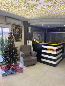 a reception area with a christmas tree and a chair at deperlas in Atakum