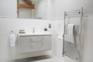 a white bathroom with a sink and a shower at The Old Granary in Barnetby le Wold +88 photos
