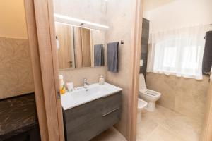 a bathroom with a sink and a toilet at Santa Lucia Affittacamere in Gioia del Colle +9 photos