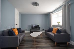 a living room with two couches and a table at Pine House By Horizon Stays in Hartlepool