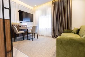 a living room with a couch and a table at RIVA sleep & chill in Valjevo