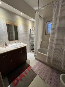 a bathroom with a sink and a tub and a shower at Alonaki House in Amfikleia