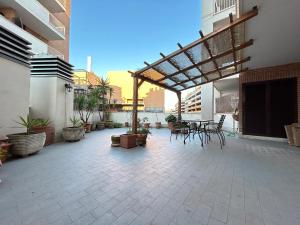 a patio with tables and chairs on a building at Nui Prestige Home in Fiumicino