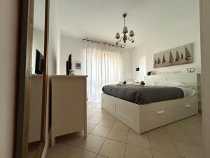 a bedroom with a bed and a television in it at Nui Prestige Home in Fiumicino