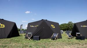 a group of tents with chairs in the grass at TT Camping Jan & Bertha - by Global-Tickets in Assen