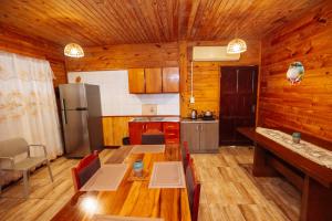 a kitchen with a table and a refrigerator in it at Cabin Renty Beach in Encarnación