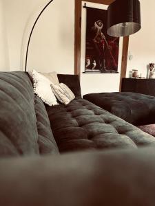 a couch in a living room with a lamp at ANINA in Meckenheim