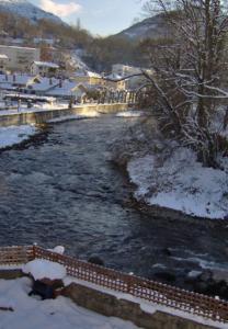 a river with snow on the side of it at Gîte du petit Taïchou in Luzenac