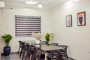 a dining room with a table and chairs at Nexus Xpress Hotel in Abuja