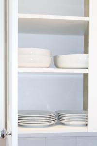 a cupboard with plates and dishes in it at Cosy house in West Yorkshire in Batley