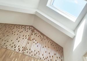 a room with a ceiling with a window and a wooden floor at Bramendijk in Groede