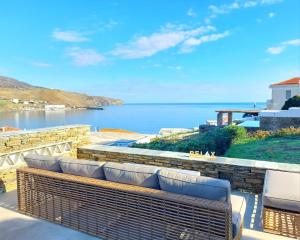 a balcony with a view of a body of water at Lasia Luxury Suite in Andros