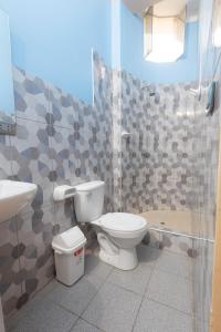 a bathroom with a toilet and a sink at Casa Grau 1590 in Tarapoto