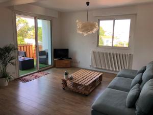 a living room with a couch and a coffee table at T3 Anglet, entre Biarritz et Bayonne in Anglet