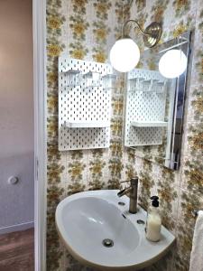 y baño con lavabo y espejo. en Sunrise Beach Apartment en Póvoa de Varzim