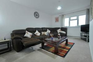 a living room with a couch and a coffee table at New Stylish 2-Bed Retreat in Central Windsor in Windsor