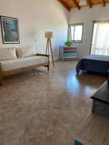 a living room with a couch and a bed at La Casita Yogui - MONOAMBIENTE 1 in Santa Rosa de Calamuchita