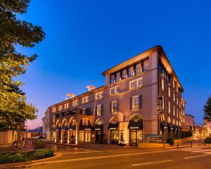 a large building on a street with a street at Hôtel de Paris Saint-Tropez in Saint-Tropez