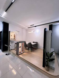a white room with a table and chairs in it at [New Double Storey] 12 to 14 Pax - SG ABONG - BRIGHT INN HOMESTAY in Muar