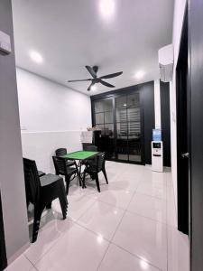 a living room with a table and chairs and a ceiling fan at [New Double Storey] 12 to 14 Pax - SG ABONG - BRIGHT INN HOMESTAY in Muar
