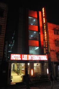 a hotel ie information sign in front of a building at Hotel Lee International in Kolkata