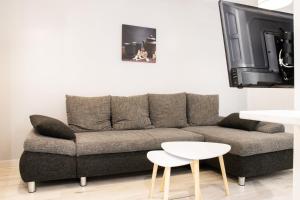 a living room with a couch and a tv at "Peace & love house" en campagne de Poitiers in Montamisé