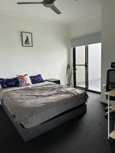 1 dormitorio con 1 cama y ventilador de techo en Best Brisbane location to enjoy vocation, en Brisbane