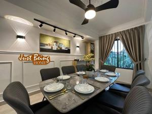 mesa de comedor con sillas y ventilador de techo en Just Being Home 10pax 3BR/3BA 4Queen/1Sofa, en Ampang