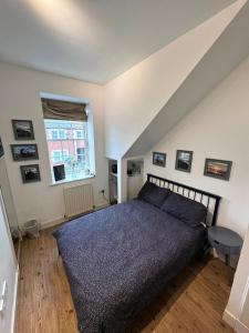 a bedroom with a bed and a window at Parade School Guest Rooms in Berwick-Upon-Tweed
