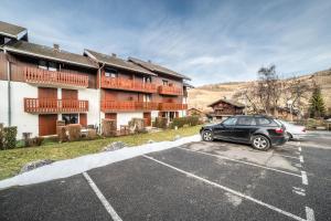 a car parked in a parking lot in front of a building at Appartement Bernex - 3 personnes in Bernex