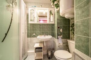 a small bathroom with a sink and a toilet at Appartement Bernex - 3 personnes in Bernex +17 photos